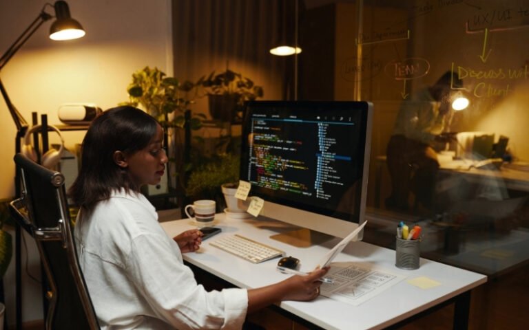 Developer working in a code editor on a monitor, providing technical support