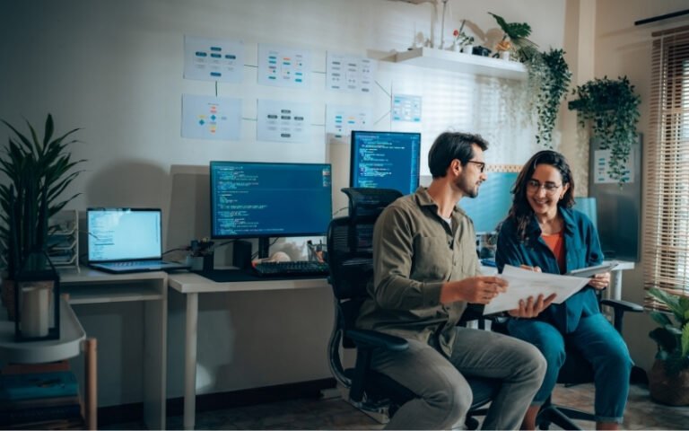 Developers reviewing site performance and technical documentation on multiple monitors